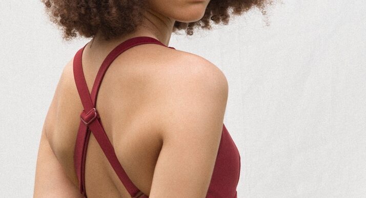 The back of the one wave terra rouge swimsuit worn.